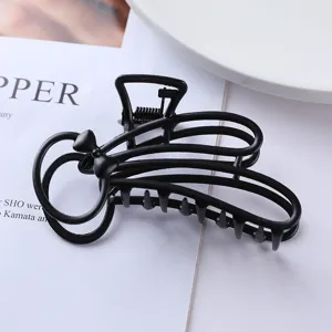 Detailed close-up view of a chic black metal hair claw clip with bowknot for daily hair styling.