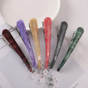 Detailed view of long acrylic acetate hair clips in multiple vibrant colors, metal duckbill design.