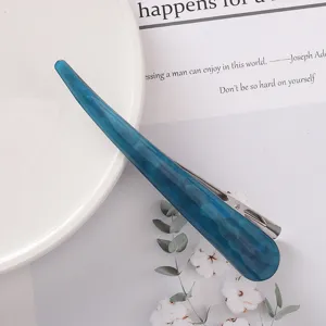 Blue acetate hair clip detail shot, elegant acrylic hair barrette for styling and updos.