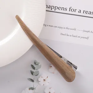 Detail view of acetate hair clip with wooden texture and metal duckbill clasp for elegant styling.