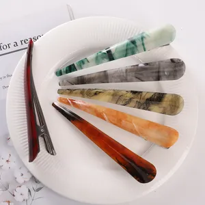 Detailed view of stylish acetate hair clips in assorted marbled colors, elegant duckbill design.