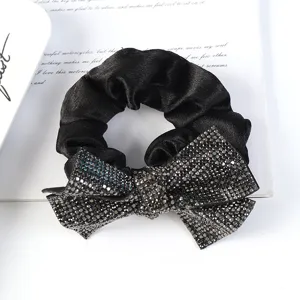 Black rhinestone bow hair scrunchie, sparkling crystal elegant hair tie detail view.