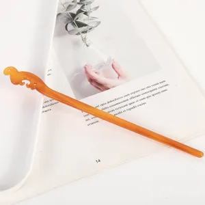 Amber acetate hair stick detail view, featuring minimalist hollow design, elegant hair accessory.