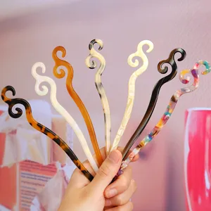 Detailed view of fashionable acetate hair sticks in multiple colors, perfect for elegant buns.