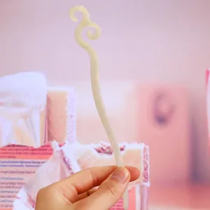 Detailed view of the elegant white acetate hair stick, showcasing its smooth texture and unique design.