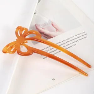 Close-up detail of the amber acetate hollow butterfly hair stick showcasing fine craftsmanship.