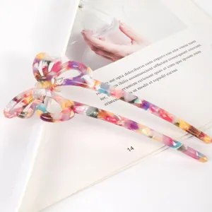 Closeup detail of colorful acetate butterfly hair stick, hollow design, elegant hair acc.