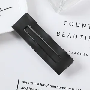 Matte black metal rectangular hair clip detail view, minimalist style hairpin accessory.