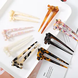 Acrylic acetate hair fork with bow design, elegant U-shaped hair stick for bun styling.