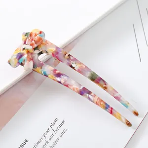 Colorful acetate hair fork with a chic hollow bow design, perfect for elegant bun hairstyles.