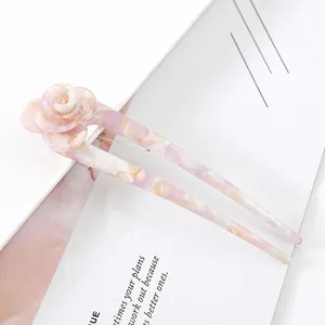 Pink acetate floral U-shaped hairpin detail shot, elegant marbled hair fork accessory for bun.