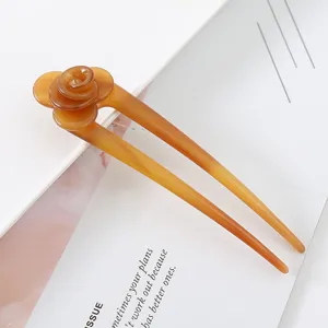 Amber U-shaped acetate hair fork detail view, elegant floral bun hairpin accessory.