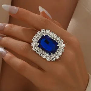Chic oversized blue crystal statement ring with dazzling rhinestone halo for women.