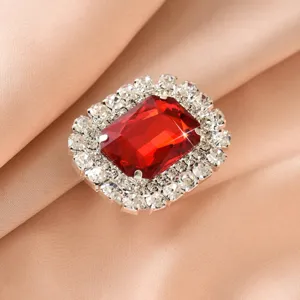 Detailed view of the square crystal ring with a brilliant red gemstone and rhinestones.