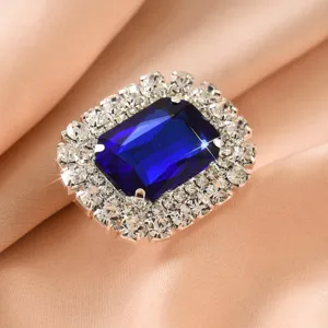 Close-up detail of a stunning square blue crystal ring featuring sparkling rhinestone halo.