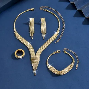 Gedetailleerd shot van sprankelende strass gouden ketting oorbellen armband ring bruid set.