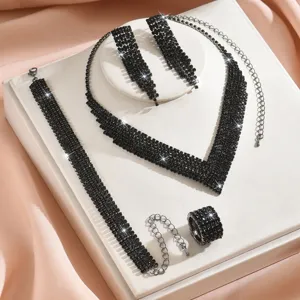 Black rhinestone jewelry set detail showcasing necklace earrings bracelet ring accessories.