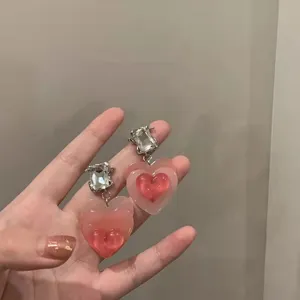Gradient pink heart resin earrings with dazzling crystal studs for stylish daily wear.