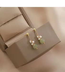 Elegant national style pearl and jade earrings detail shot, minimalist 925 silver jewelry.