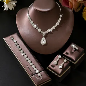 Bridal rhinestone jewelry set detail featuring sparkling teardrop necklace, bracelet, earrings.