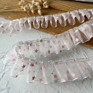 Sheer organza ruffled ribbon lace trim with pink star print, ideal for DIY crafts and doll clothes.