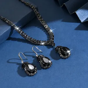 Dettaglio della parure con collana e orecchini in zirconi neri a goccia, design elegante e chic.