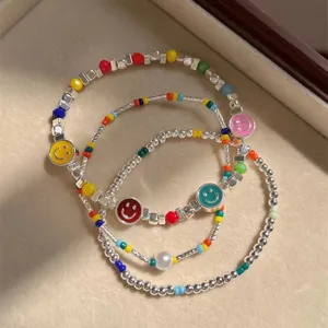 Layered beaded bracelet set with colorful smiley charms and silver beads for women stackable