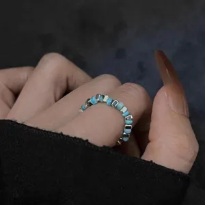Beaded stretch ring detail shot showcasing colorful stone and silver spacers on finger.