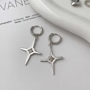 Silver zircon cross dangle earrings, niche design chic fashion ear clips for women detail shot.