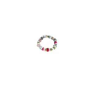 Close-up of colorful beaded elastic ring, delicate detail showing mixed stones and silver beads.