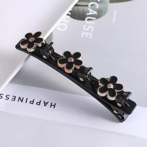 Zwarte meerlagige haarspeld met bloemdecoratie, elegante detailweergave voor damstylen.