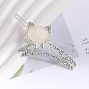 Rhinestone cat hair clip detail, silver metal side clip with sparkly crystals and cute design.