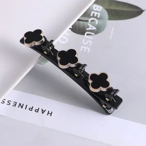 Zwarte dubbele haarclip met klaverbladontwerp, elegante stylingtool voor vrouwen.