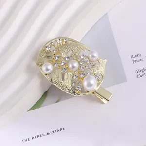 Exquisite detail close-up of a Korean style metal hair clip adorned with pearls and rhinestones.
