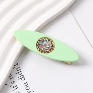 Light green resin duckbill hair clip with sparkly rhinestone center detail, elegant design.
