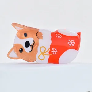 Cute acrylic corgi hair claw featuring a festive Christmas design, perfect holiday gift accessory.