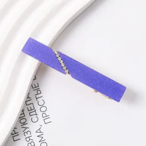 Detailed shot of purple glitter resin hair clip with sparkling rhinestones for cute styling.