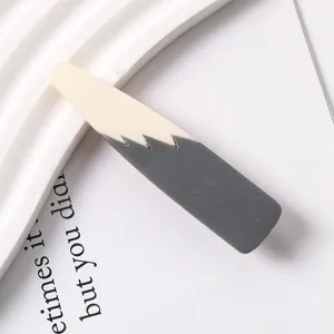 Detailed close-up shot of the two-tone resin duckbill hair clip with smooth texture.