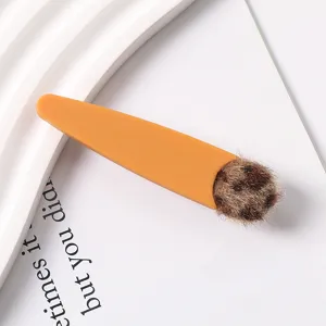 Close-up detail of the cute Korean style resin hair clip featuring fluffy leopard plush pom pom.