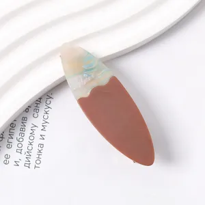Detailed view of the color-block resin hair clip with unique blue and brown design.