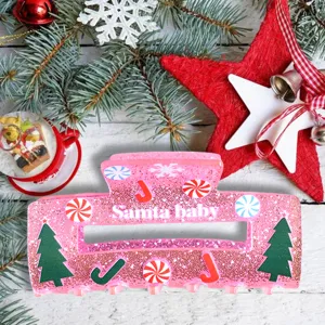 Christmas glitter hair claw clip detail shot, pink festive design with holiday elements.