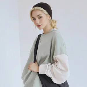 Detailed view of a soft knitted sports headband, comfortable wide elastic hair band for yoga.