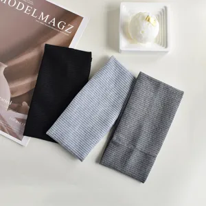 Detailed shot of ribbed knit yoga headbands, showing soft texture and elastic design.