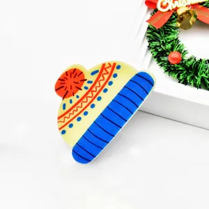 Close-up detail of a festive Christmas hat-shaped hair claw clip, colorful and fun.
