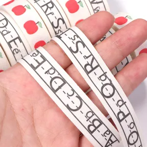 Cotton ribbon featuring cute apple and alphabet print, perfect for DIY gift wrapping and party decor.