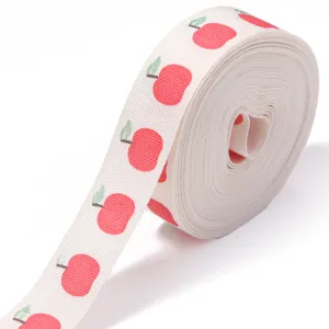 Red apple patterned cotton ribbon roll for DIY gift wrapping and party decoration crafts.