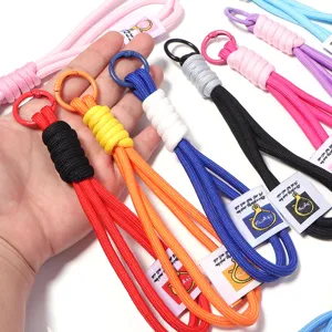 Detailed view of colorful woven lanyard wrist strap with metal ring, close-up shot.