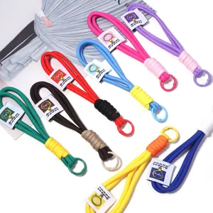 Detailed view of colorful braided lanyards with metal rings and tags for everyday carry accessories.