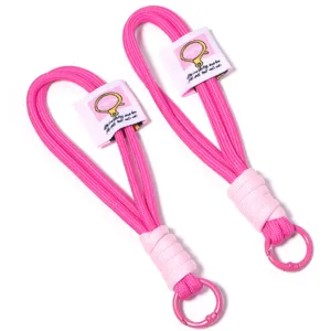 Pink woven lanyard strap for keychains phone charms bags DIY accessories stylish and durable.