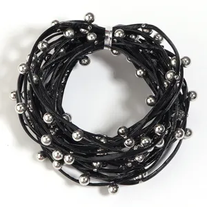 Punk style black multi-strand leather cord necklace with silver metal beads detail view.